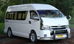 A side view of a sleek and elegant Toyota Commuter luxury van parked against a scenic backdrop, showcasing its stylish design and sophistication