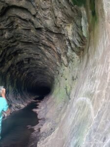A view inside the dark and mysterious Anchuruli Tunnel, known for its echo and cool airflow."